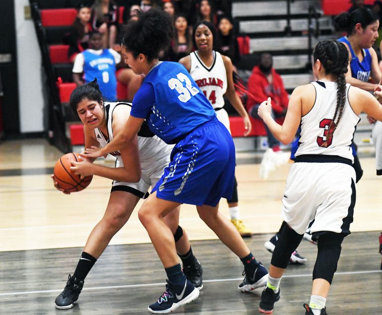 Spartans top Trojans, 42-29, to stay on top of league standings