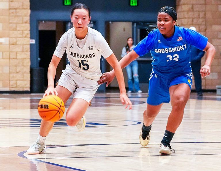 Mater Dei Catholic's Jarika Chan brings the ball up court against Grossmont's Maya Shehee in Open Division quarterfinal playoff game. Photo by Jon Bigornia